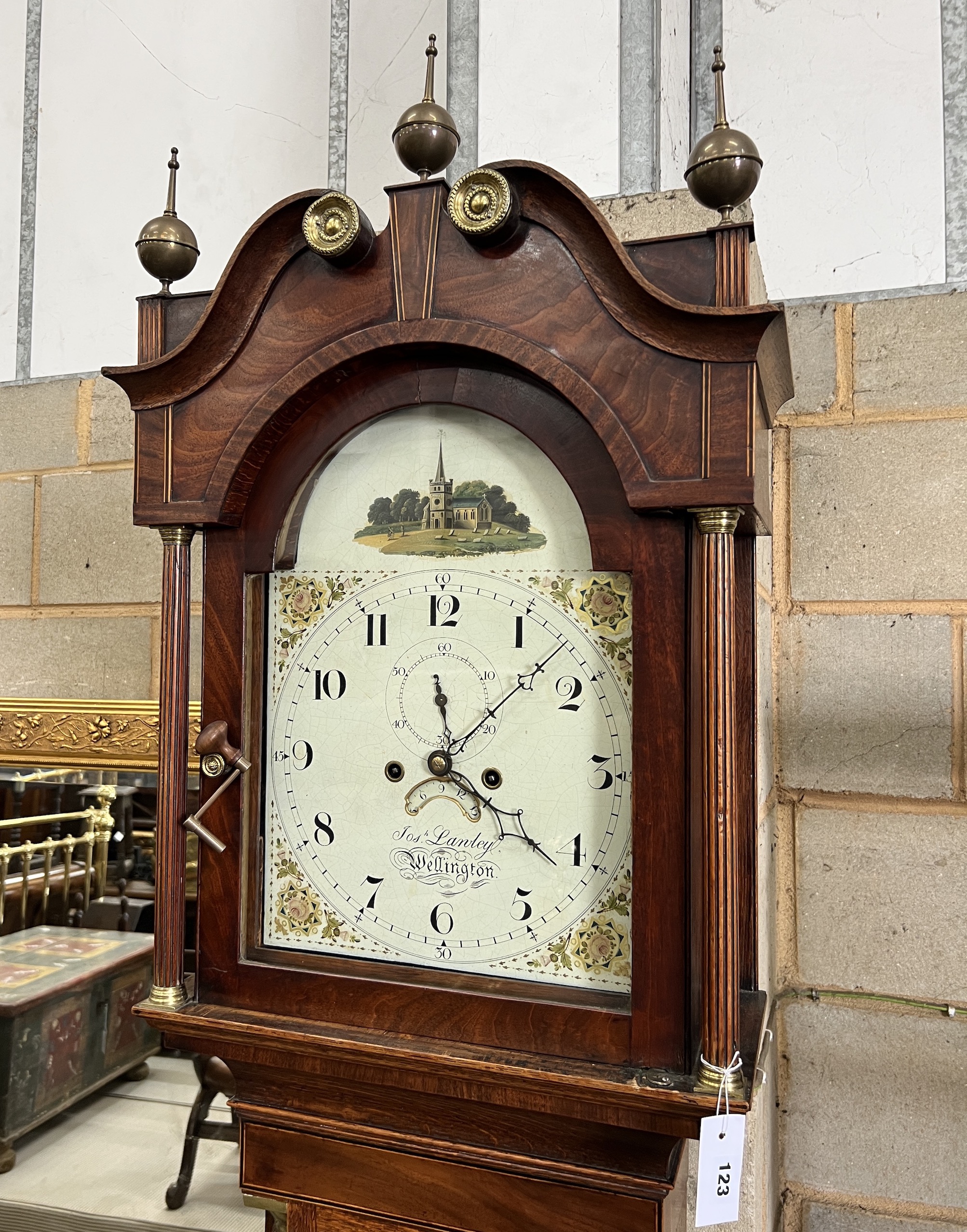 A late 18th century mahogany banded oak eight day longcase clock, with an arched painted dial marked Lanley, Wellington, height 228cm